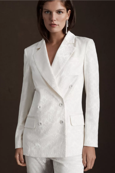 model wearing white brocade bridal suit